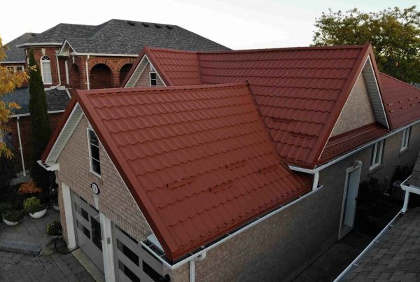 Full view of a brick red metal roof on a modern home.